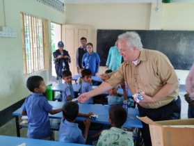 Distributing biscuits among the schoolchildren Ukhiya